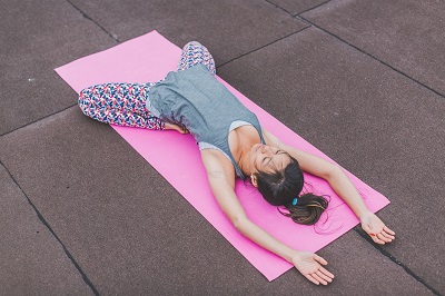 femme qui fait du yoga sur un tapis