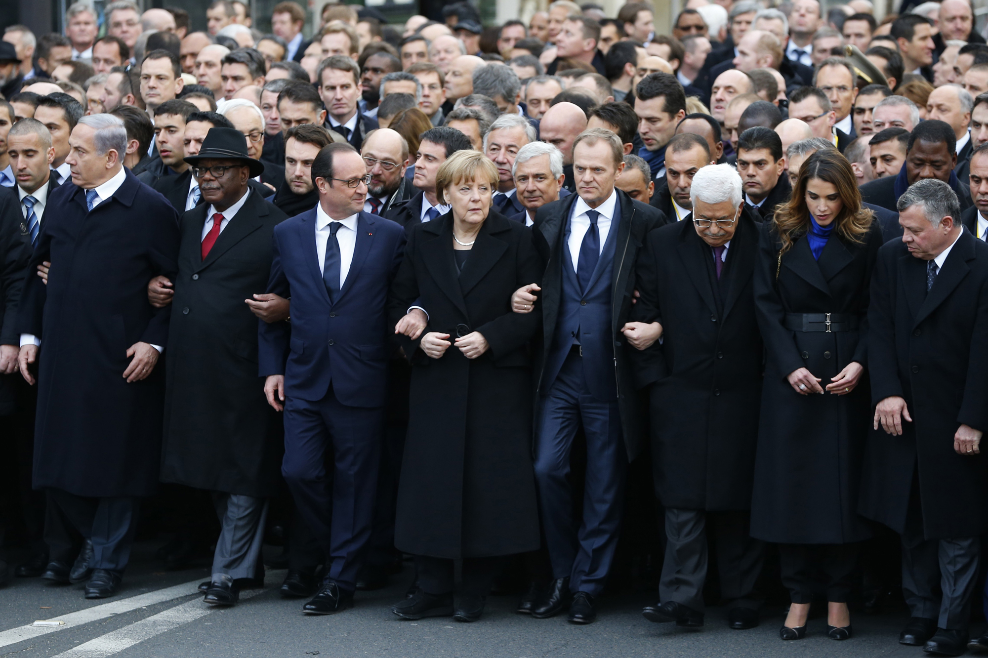 French President Hollande is surrounded by head of states as they attend the solidarity march in the streets of Paris
